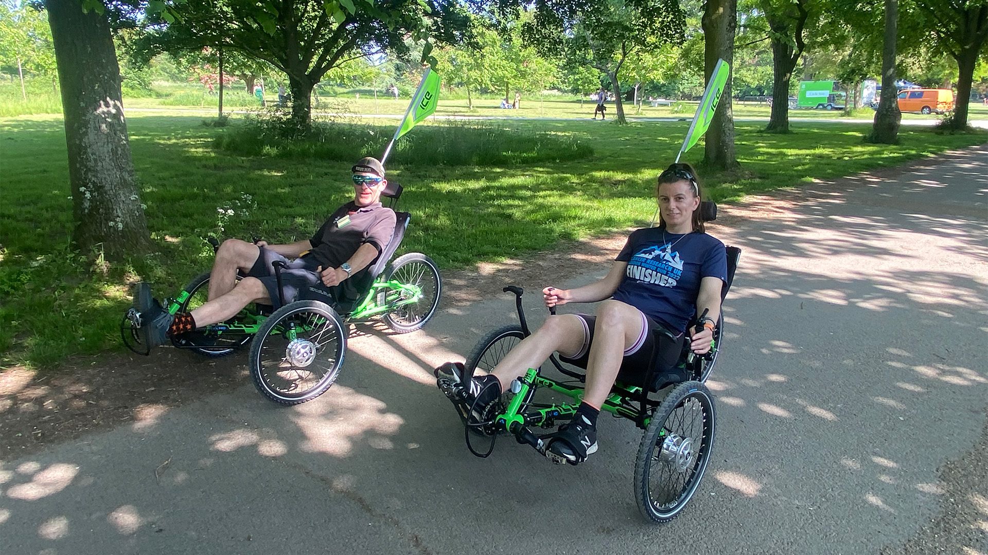 two trike riders in the trees